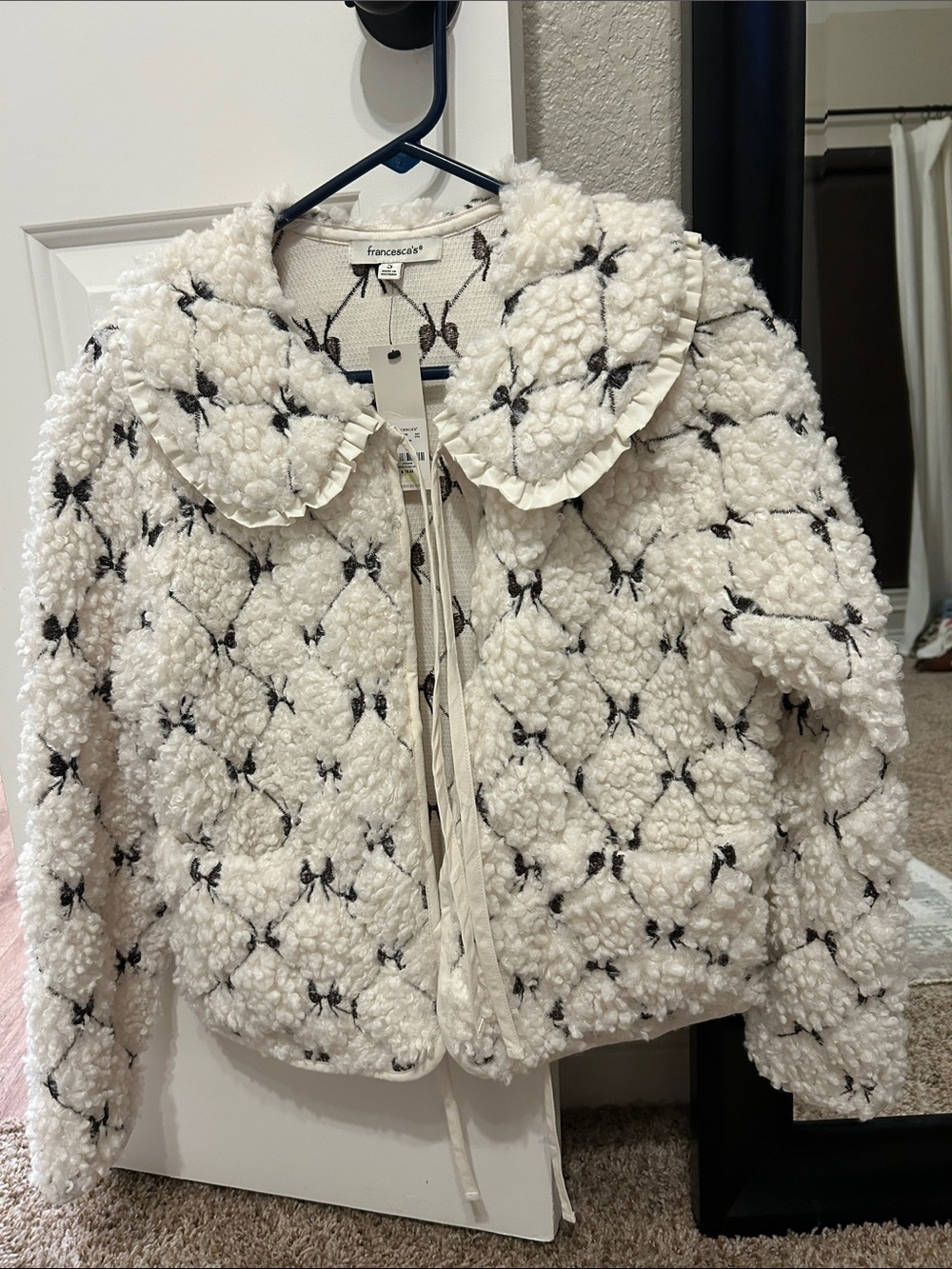 Francesca's Collections Cream Bouclé Teddy Jacket with Black Bow Accents